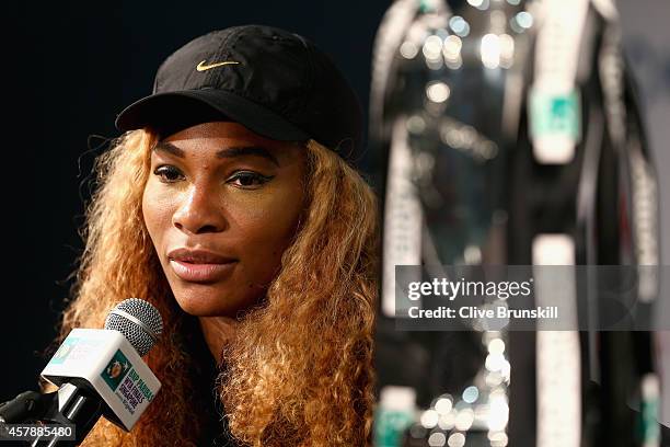 Serena Williams of the United States with the Billie Jean King Trophy as she answers questions from the media in her press conference after her...