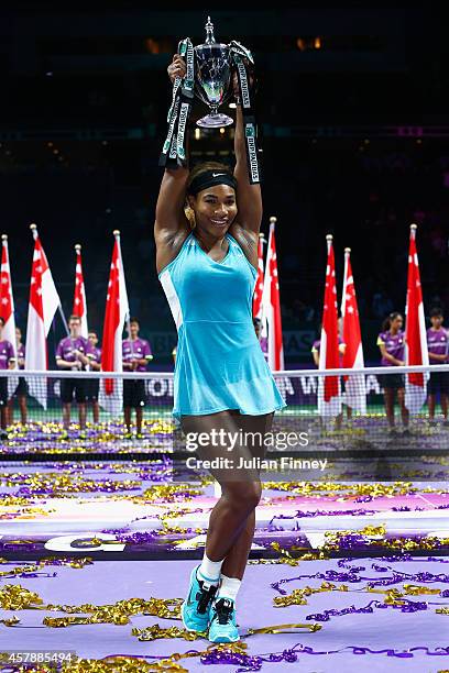 Serena Williams of USA celebrates with the Billie Jean King trophy after she defeats Simona Halep of Romania in the final during day seven of the BNP...