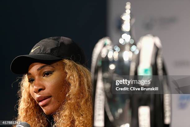 Serena Williams of the United States with the Billie Jean King Trophy as she answers questions from the media in her press conference after her...