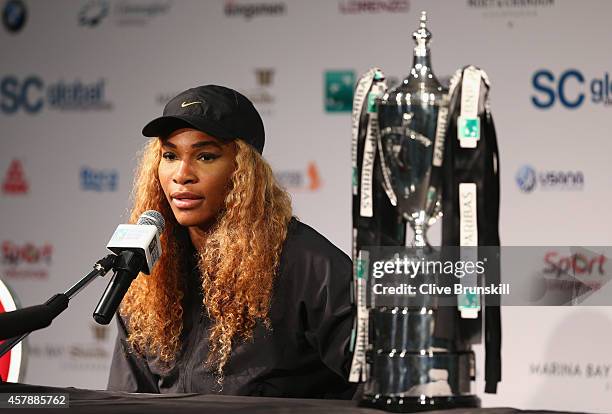 Serena Williams of the United States with the Billie Jean King Trophy as she answers questions from the media in her press conference after her...