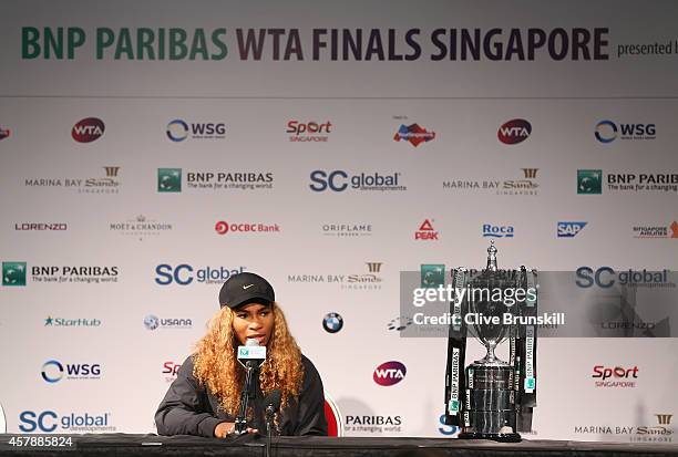 Serena Williams of the United States with the Billie Jean King Trophy as she answers questions from the media in her press conference after her...