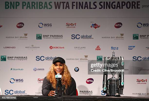 Serena Williams of the United States with the Billie Jean King Trophy as she answers questions from the media in her press conference after her...