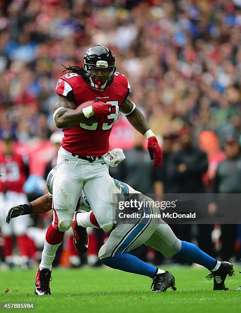 Joplo Bartu of the Atlanta Falcons evades the tackle of DeAndre Levy of the Detroit Lions during the NFL match between Detroit Lions and Atlanta...