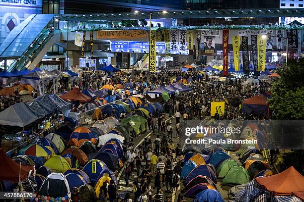 People walk among tents along the main protest campsite October 26, 2014 in Hong Kong. At the main protest site a peaceful atmosphere remains as...