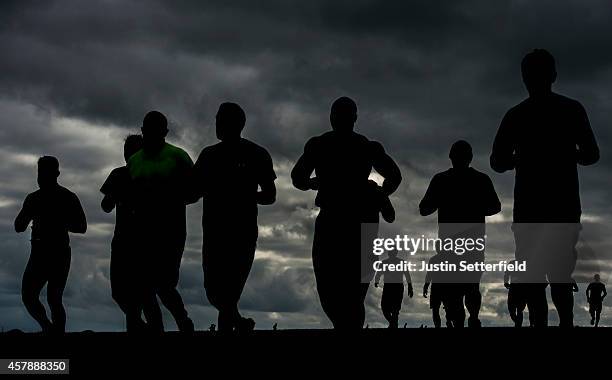 Competitors take part in the Tough Mudder London South on October 26, 2014 in Winchester, England. The world-famous Tough Mudder is military style...