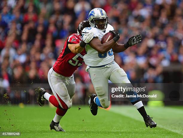 Prince Shembo of the Atlanta Falcons tackles Stephen Tulloch of the Detroit Lions during the NFL match between Detroit Lions and Atlanta Falcons at...