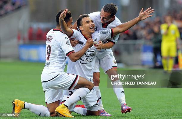 Nice's Brazilian midfielder Carlos Eduardo is congratulated by his teammates after scoring during the start of the French L1 football match Guingamp...