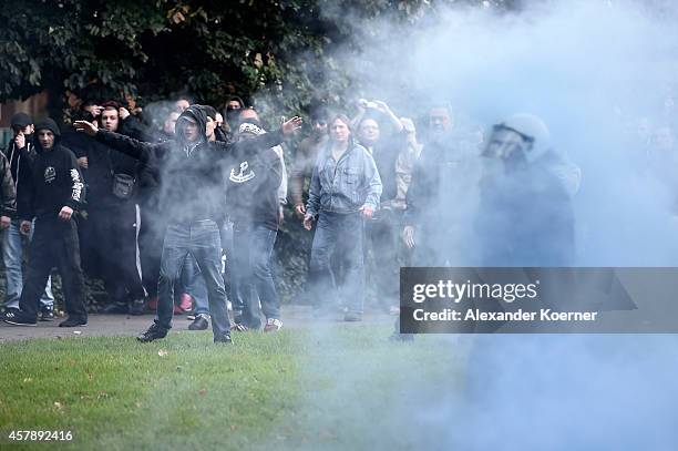 Hooligans clash with police as they gather to protest against the hard-line Salafist movement on October 26, 2014 in Cologne, Germany. Hooligans,...