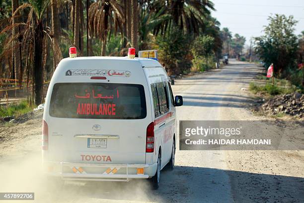 An Ambulance drives down a street in the Jurf al-Sakhr area, north of the Shiite shrine city of Karbala on October 26, 2014. Iraqi officials said...