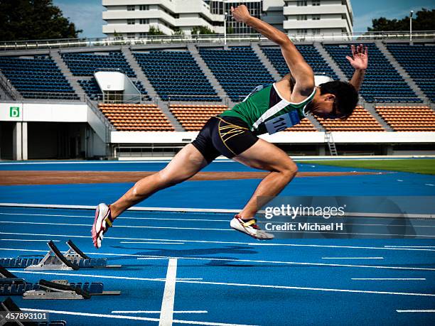 male athlte starting from blocks on track - running man profile stock pictures, royalty-free photos & images