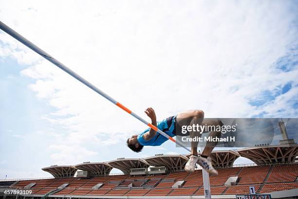male athlete performing high jump - high jumper stock pictures, royalty-free photos & images