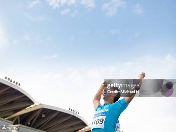 a athlete raising his arm in triumph - 24 h du mans bildbanksfoton och bilder