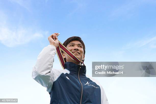 athlete smiling on podium with the medal - holding medal stock pictures, royalty-free photos & images