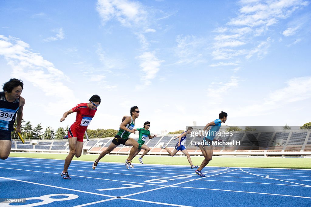 Male athletes running to the finish line