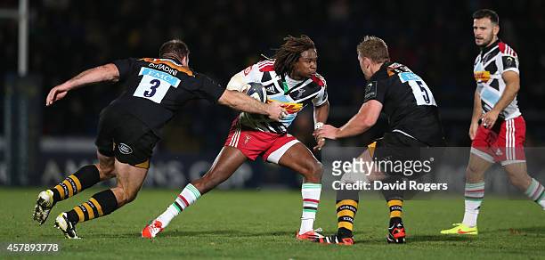 Marland Yarde of Harlequins takes on Lorenzo Cittadini and Bradley Davies during the European Rugby Champions Cup match between Wasps and Harlequins...