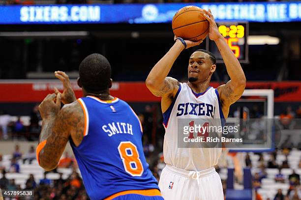 McDaniels of the Philadelphia 76ers takes a shot over the defense of J.R. Smith of the New York Knicks during a preseason game at the Carrier Dome on...