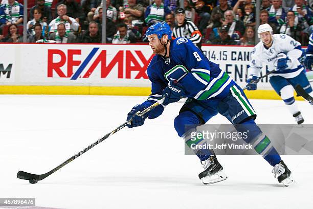 Zack Kassian of the Vancouver Canucks skates up ice with the puck during their NHL game against theTampa Bay Lightning at Rogers Arena October 18,...