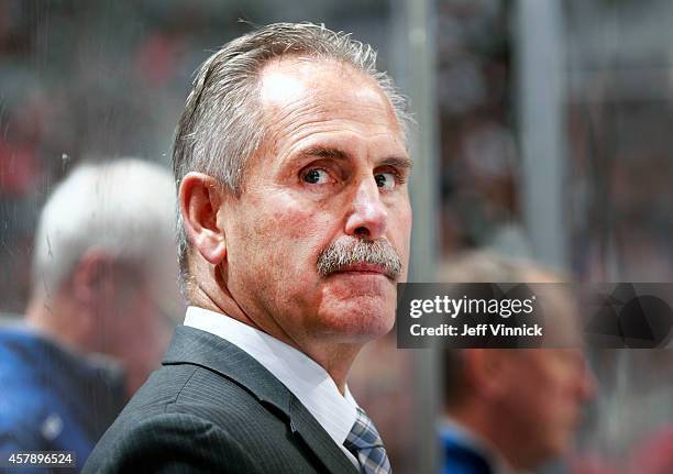 Head coach Willie Desjardins of the Vancouver Canucks looks on from the bench looks on from the bench during their NHL game against theTampa Bay...