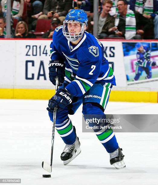 Dan Hamhuis of the Vancouver Canucks skates up ice with the puck during their NHL game against theTampa Bay Lightning at Rogers Arena October 18,...