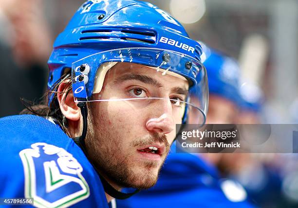 Christopher Tanev of the Vancouver Canucks looks on from the bench during their NHL game against theTampa Bay Lightning at Rogers Arena October 18,...