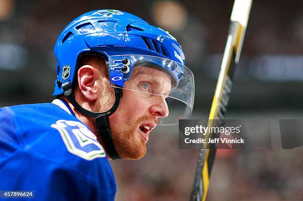 Daniel Sedin of the Vancouver Canucks looks on from the bench during their NHL game against theTampa Bay Lightning at Rogers Arena October 18, 2014...