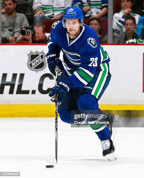 Alexander Edler of the Vancouver Canucks skates up ice with the puck during their NHL game against theTampa Bay Lightning at Rogers Arena October 18,...