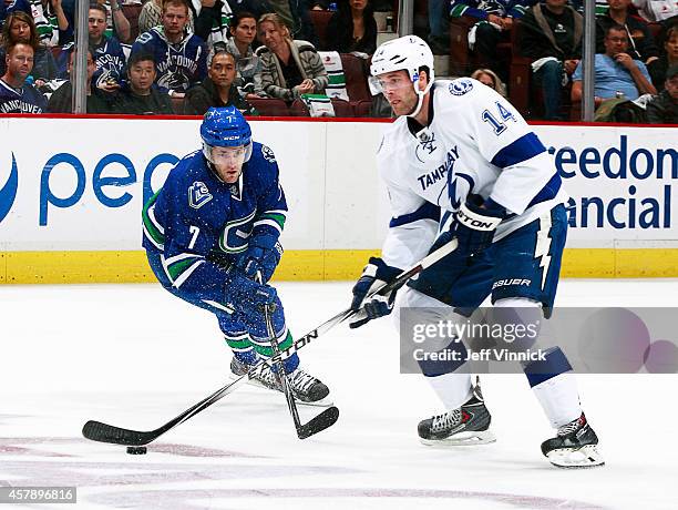 Linden Vey of the Vancouver Canucks and Brett Connolly of the Tampa Bay Lightning battle for a loose puck during their NHL game at Rogers Arena...