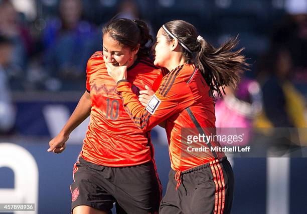 Sandra Stephany Mayor and Kenti Robles of Mexico react after Mayor scored a goal ini the first half against Trinidad & Tobago to the 2014 CONCACAF...
