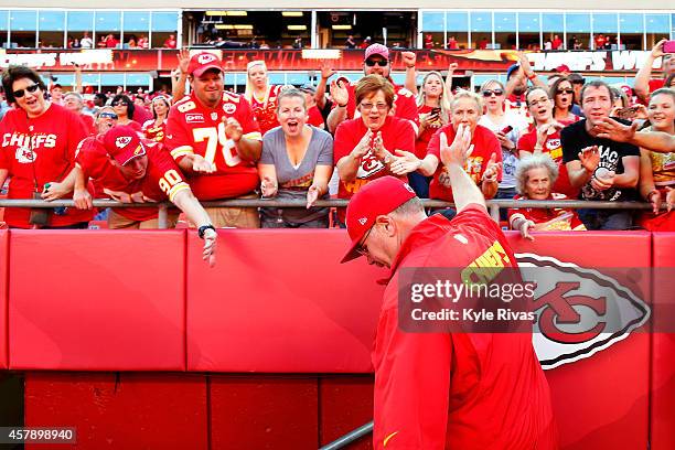 Head coach Andy Reid of the Kansas City Chiefs waves to cheering fans after defeating the St. Louis Rams 34-7 at Arrowhead Stadium on October 26,...