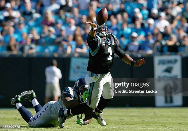 Greg Scruggs of the Seattle Seahawks hits Cam Newton of the Carolina Panthers as he throws an interception during the game at Bank of America Stadium...