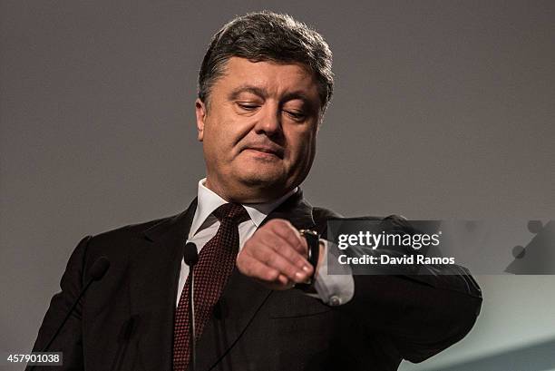 Ukrainian President Petro Poroshenko checks his watch as he speaks to the media on October 26, 2014 in Kiev, Ukraine. Although a low turn out is...