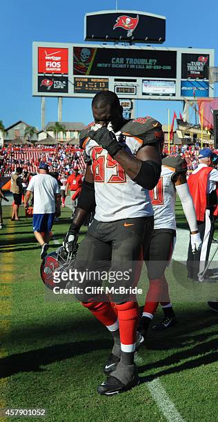 Tackle Demar Dotson of the Tampa Bay Buccaneers walks off the field after their loss in overtime to the Minnesota Vikings at Raymond James Stadium on...