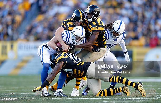 Griff Whalen of the Indianapolis Colts is tackled by Shaun Suisham, Cortez Allen and Robert Golden of the Pittsburgh Steelers during the first...