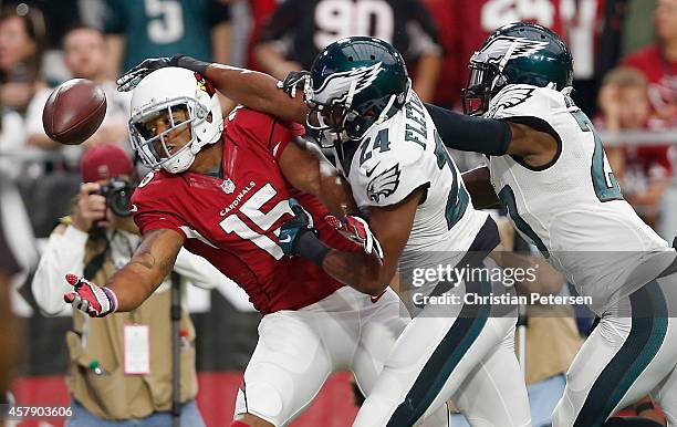 Wide receiver Michael Floyd of the Arizona Cardinals attempts to make a catch against cornerback Bradley Fletcher and free safety Malcolm Jenkins of...