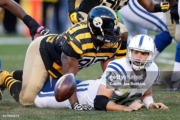 Andrew Luck of the Indianapolis Colts fumbles the ball after being hit by James Harrison of the Pittsburgh Steelers during the second quarter at...