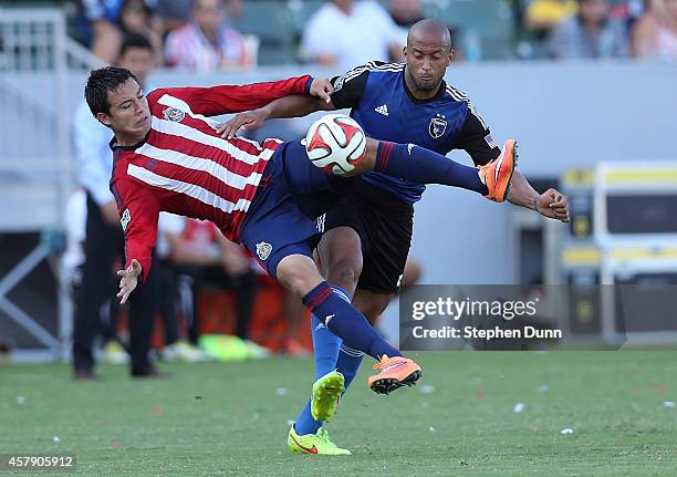 Erick Torres of Chivas USA jumps to clear the ball away from Victor Bernardez of the San Jose Earthquakes at StubHub Center on October 26, 2014 in...