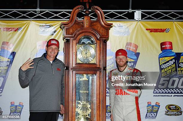 Dale Earnhardt Jr., driver of the National Guard Chevrolet, right, and crew chief Steve Letarte pose with the trophy in Victory Lane after winning...