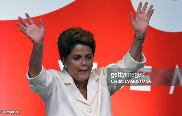 Re-elected Brazilian President Dilma Rousseff waves following her win, in Brasilia on October 26, 2014. Leftist incumbent Dilma Rousseff was...