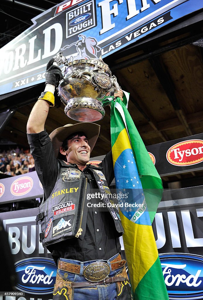 Professional bull rider Silvano Alves of Brazil, hoists the PBR World ...