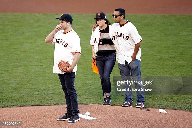 Zak Williams, son of Robin Williams, throws out the ceremonial first pitch as Zelda and Cody Williams look on before Game Five of the 2014 World...