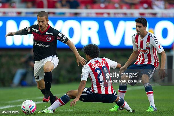 Giovani Hernandez of Chivas fights for the ball with Dario Benedetto of Tijuana during a match between Chivas v Tijuana as part of Apertura 2014 Liga...