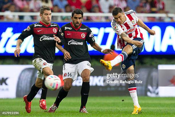 Jorge Enríquez of Chivas fights for the ball with Cristian Pellerano of Tijuana during a match between Chivas v Tijuana as part of Apertura 2014 Liga...