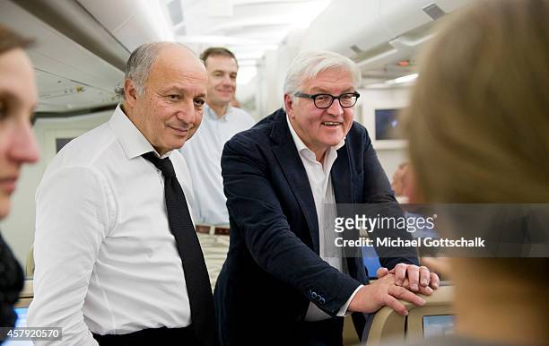 Foreign Ministers Laurent Fabius of France and Frank-Walter Steinmeier of Germany chat on a German air force airplane at Orly Aiport prior their...