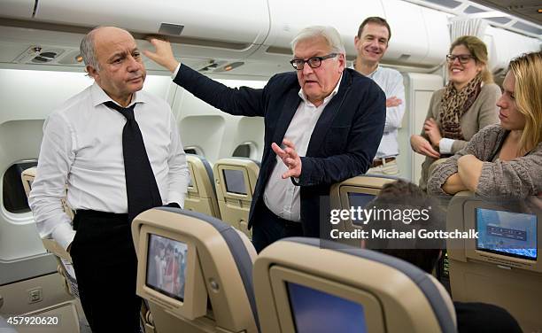 Foreign Ministers Laurent Fabius of France and Frank-Walter Steinmeier of Germany chat on a German air force airplane at Orly Aiport prior their...