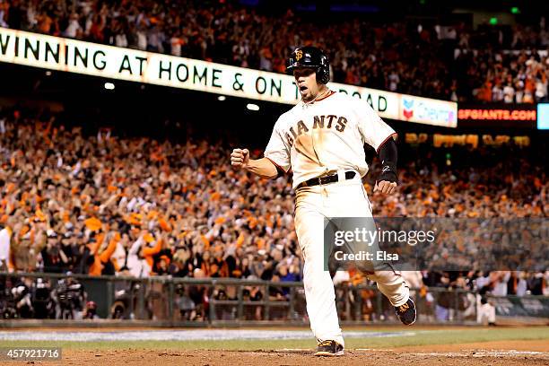 Juan Perez of the San Francisco Giants scores in the eighth inning off a hit by Brandon Crawford against the Kansas City Royals during Game Five of...