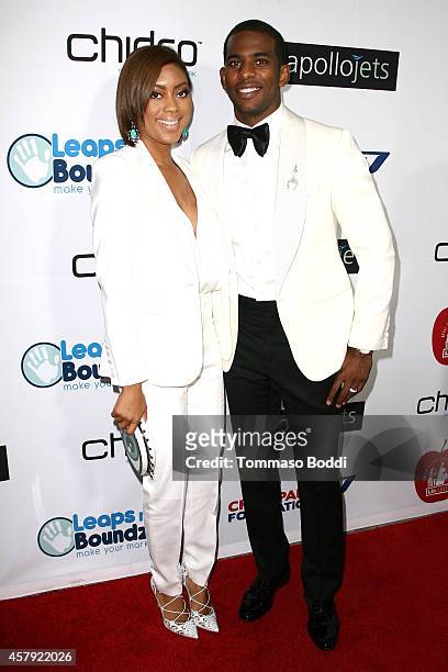Basketball player Chris Paul and Jada Crawley attend the CP3 Foundation celebrity server dinner at Mastro's Steakhouse on October 26, 2014 in Beverly...