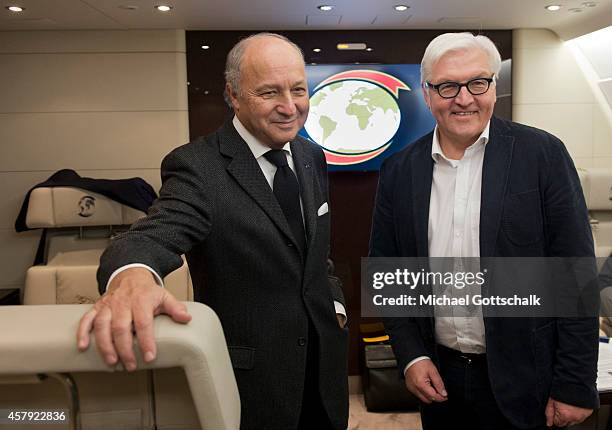 Foreign Ministers Laurent Fabius of France and Frank-Walter Steinmeier of Germany chat on a German air force airplane at Orly Aiport prior their...