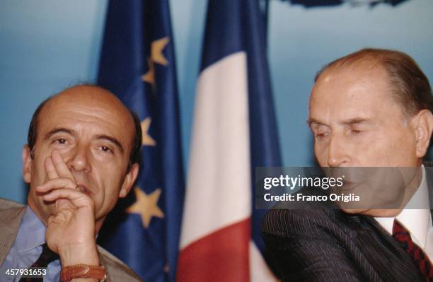 French Foreign Minister Alain Juppe and French President Francois Mitterrand attend a conference during the G7 Summit at the Royal Palace of Naples,...