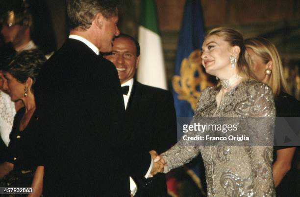Veronica Lario, Second wife of Italian Prime Minister Silvio Berlusconi, shakes hands with 42nd President of the United States Bill Clinton, at the...