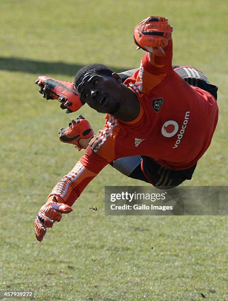 Senzo Meyiwa dives during the Orlando Pirates media open day at Rand Stadium on July 30, 2014 in Johannesburg, South Africa.